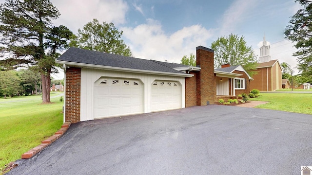 700 S 16th, Murray, KY 42071 - view of front of house featuring a chimney, asphalt driveway, brick siding, and a front yard