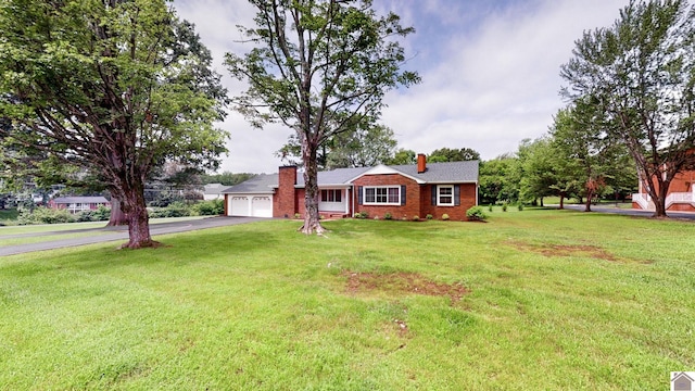 700 S 16th, Murray, KY 42071 - ranch-style house with driveway, a chimney, an attached garage, brick siding, and a front lawn