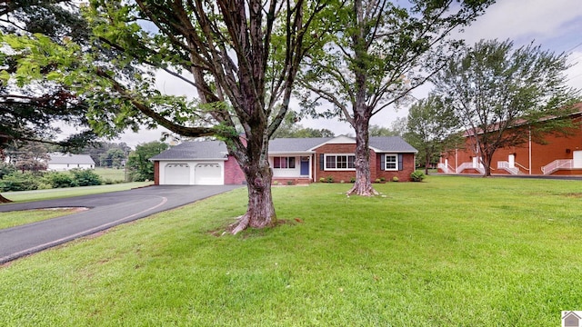 700 S 16th, Murray, KY 42071 - ranch-style house with driveway, an attached garage, a front lawn, and brick siding