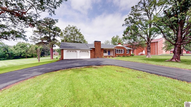700 S 16th, Murray, KY 42071 - ranch-style home featuring asphalt driveway, an attached garage, a chimney, and a front lawn