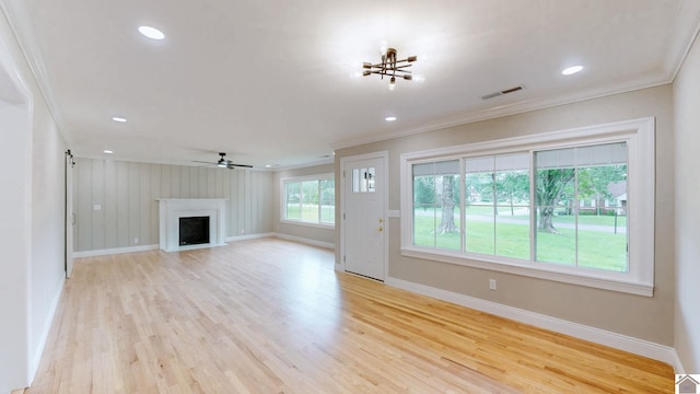 700 S 16th, Murray, KY 42071 - unfurnished living room with crown molding, light wood-style flooring, a fireplace, a chandelier, and ceiling fan