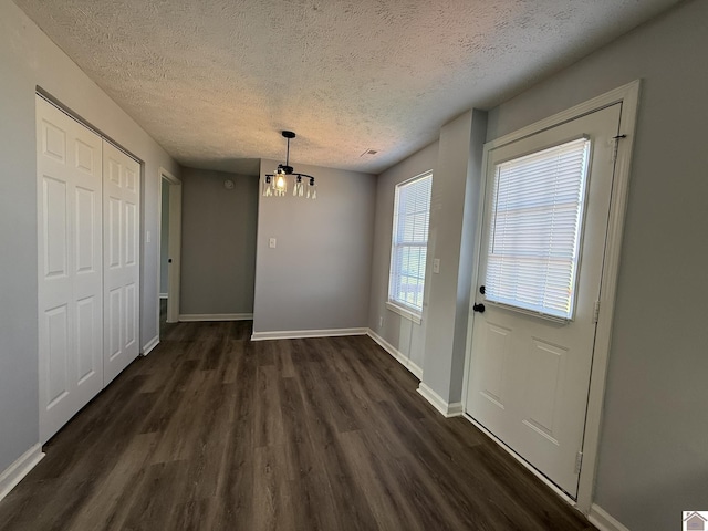 2042 Carneal Ln, Oak Grove, KY 42262 - unfurnished dining area featuring dark wood-style flooring and a textured ceiling