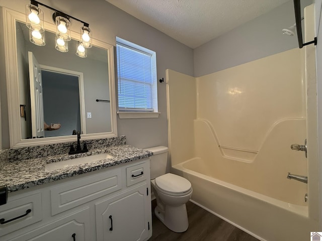 2042 Carneal Ln, Oak Grove, KY 42262 - full bath with wood finished floors, vanity, shower / bathtub combination, and a textured ceiling