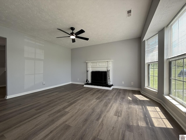 2042 Carneal Ln, Oak Grove, KY 42262 - unfurnished living room featuring dark wood-style flooring, a textured ceiling, a ceiling fan, and a fireplace with raised hearth