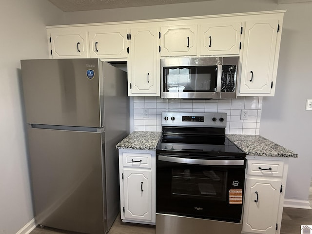 2042 Carneal Ln, Oak Grove, KY 42262 - kitchen with stainless steel appliances, decorative backsplash, and white cabinetry