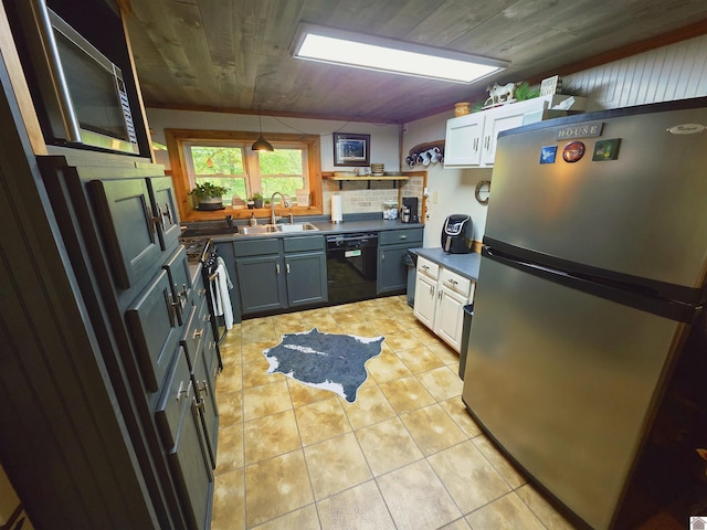 1040 Shine Ln, Cadiz, KY 42211 - kitchen with stainless steel appliances, dark countertops, wooden ceiling, light tile patterned floors, and white cabinets