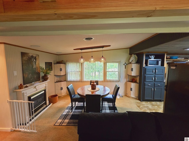 1040 Shine Ln, Cadiz, KY 42211 - dining space with light carpet, ornamental molding, and a glass covered fireplace
