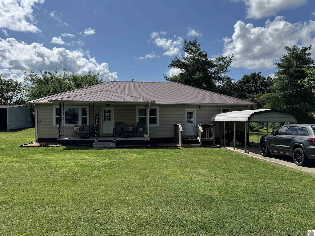 608 Downs St, Princeton, KY 42445 - rear view of property with a lawn, covered porch, a detached carport, and a metal roof