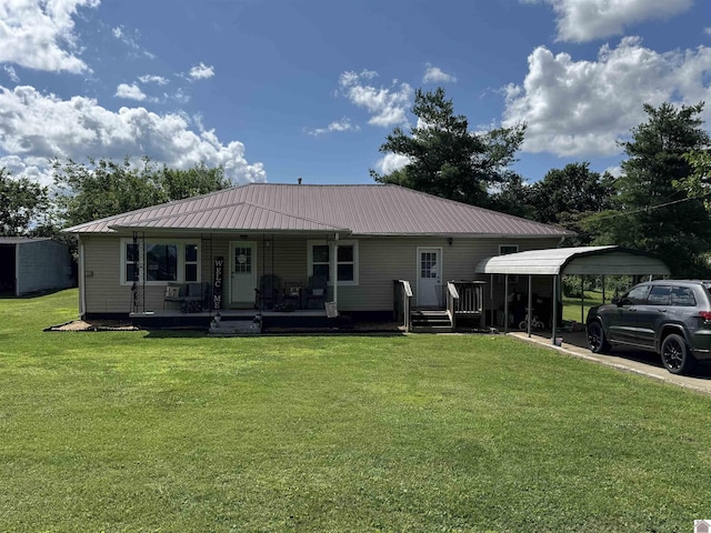 608 Downs St, Princeton, KY 42445 - rear view of property with a lawn, covered porch, a detached carport, and a metal roof