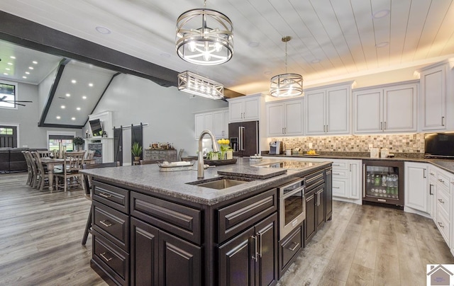 1 Logan Trl, Murray, KY 42071 - kitchen with beverage cooler, a chandelier, high end fridge, white cabinetry, and tasteful backsplash