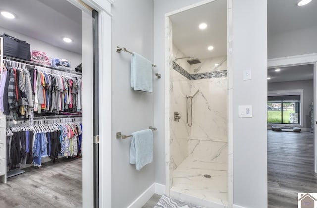 1 Logan Trl, Murray, KY 42071 - full bathroom featuring a marble finish shower, wood finished floors, a walk in closet, and recessed lighting