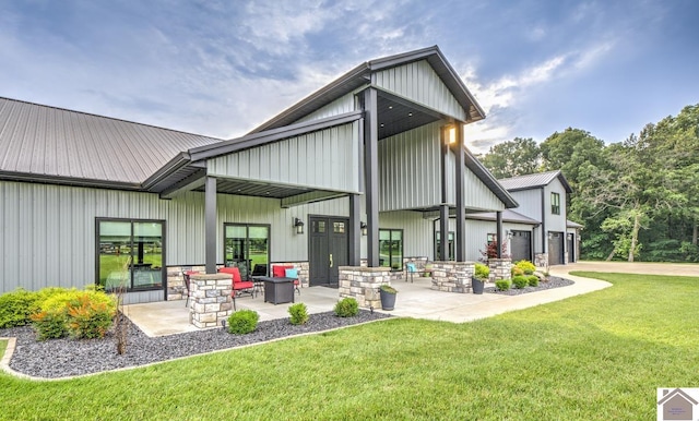 1 Logan Trl, Murray, KY 42071 - rear view of house with a yard, board and batten siding, stone siding, and a garage