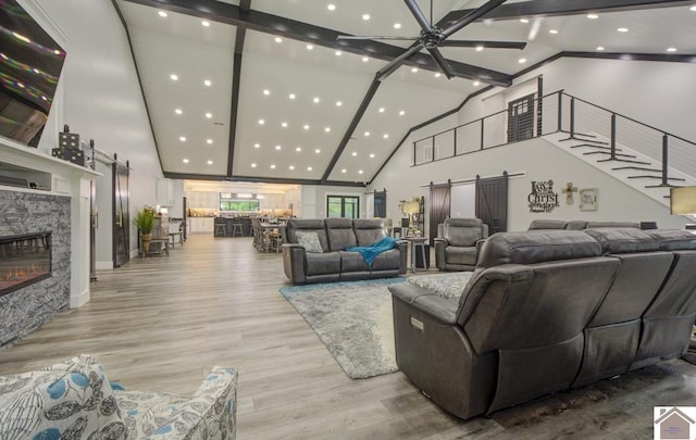 1 Logan Trl, Murray, KY 42071 - living area featuring high vaulted ceiling, a barn door, recessed lighting, wood finished floors, and ceiling fan