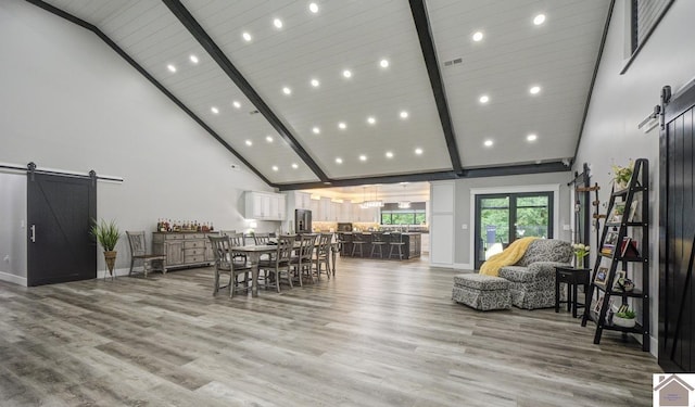 1 Logan Trl, Murray, KY 42071 - dining space with a barn door, high vaulted ceiling, beamed ceiling, light wood-style flooring, and recessed lighting