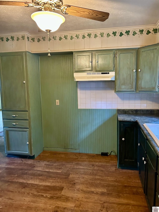 2153 Horace Barnes Rd, Calvert City, KY 42029 - kitchen featuring green cabinets, dark wood-type flooring, under cabinet range hood, and dark countertops