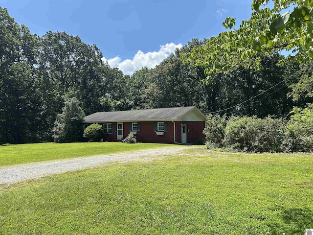 2153 Horace Barnes Rd, Calvert City, KY 42029 - ranch-style home with a front yard and gravel driveway