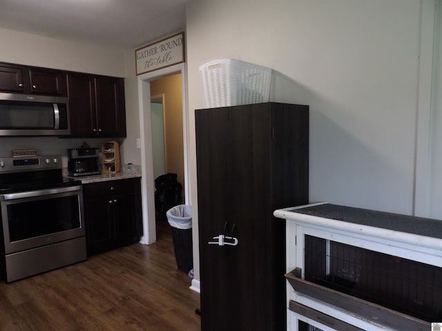 719 Elder St, Calvert City, KY 42029 - kitchen with stainless steel appliances, dark wood-style floors, and dark brown cabinetry