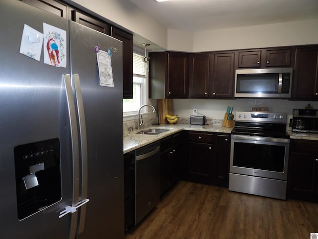 719 Elder St, Calvert City, KY 42029 - kitchen featuring stainless steel appliances, dark brown cabinetry, light stone countertops, and dark wood-style flooring