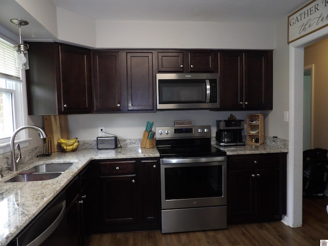 719 Elder St, Calvert City, KY 42029 - kitchen with stainless steel appliances, dark wood finished floors, dark brown cabinets, and light stone counters