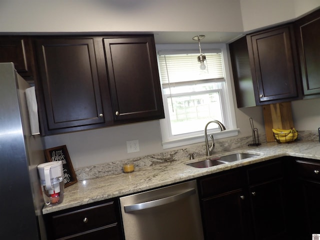 719 Elder St, Calvert City, KY 42029 - kitchen with appliances with stainless steel finishes, healthy amount of natural light, dark brown cabinetry, and light stone counters