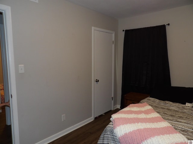 719 Elder St, Calvert City, KY 42029 - bedroom featuring dark wood-type flooring and baseboards