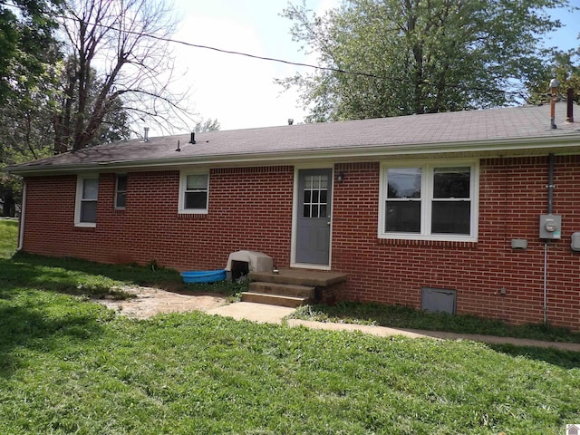 719 Elder St, Calvert City, KY 42029 - rear view of house with brick siding, a yard, and roof with shingles