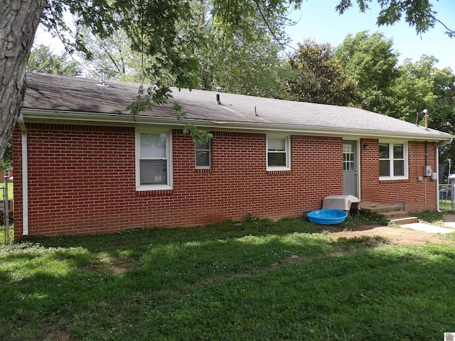 719 Elder St, Calvert City, KY 42029 - view of side of home featuring brick siding, a yard, and a shingled roof