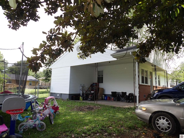719 Elder St, Calvert City, KY 42029 - view of side of home featuring a carport