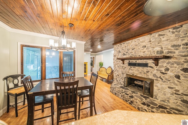 150 Sills Ln, Benton, KY 42025 - dining area with ornamental molding, wood finished floors, a stone fireplace, wooden ceiling, and a chandelier