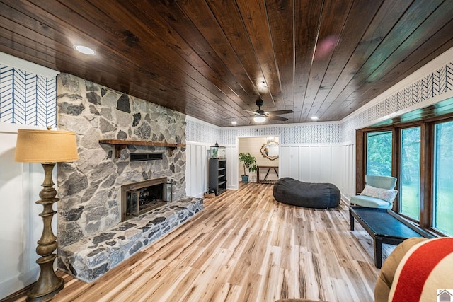 150 Sills Ln, Benton, KY 42025 - living room featuring wood ceiling, wallpapered walls, wood finished floors, a ceiling fan, and a stone fireplace