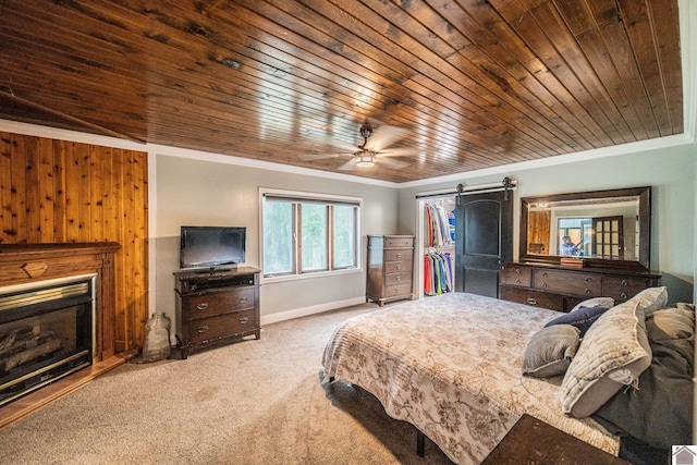 150 Sills Ln, Benton, KY 42025 - carpeted bedroom featuring crown molding, wood ceiling, a fireplace, a barn door, and a ceiling fan
