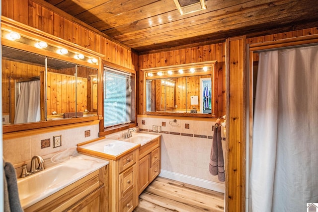 150 Sills Ln, Benton, KY 42025 - full bath with wooden ceiling, wood finished floors, two vanities, tile walls, and wooden walls
