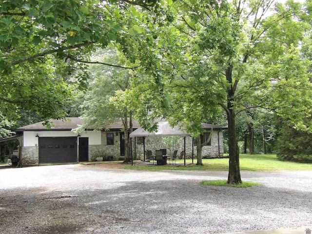 150 Sills Ln, Benton, KY 42025 - view of front of home featuring stone siding, a garage, and driveway
