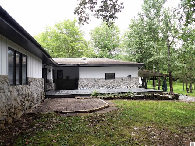 150 Sills Ln, Benton, KY 42025 - view of side of home with stone siding, a patio area, and a yard
