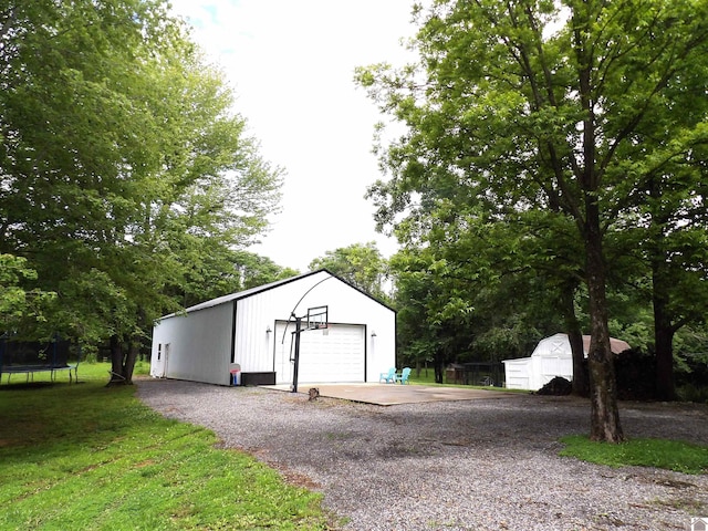 150 Sills Ln, Benton, KY 42025 - detached garage featuring a trampoline and gravel driveway