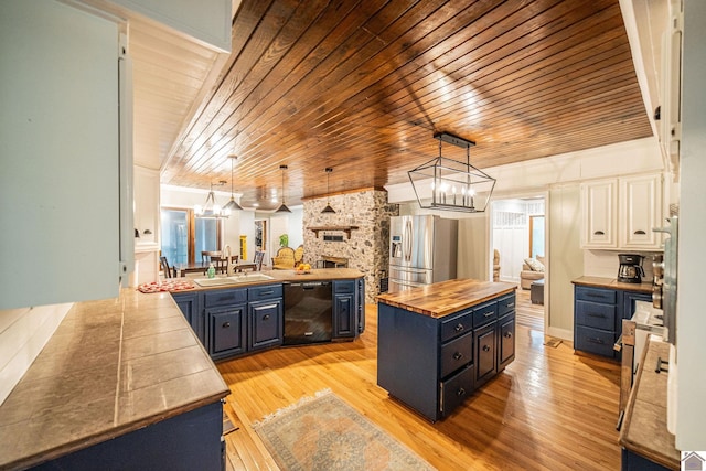 150 Sills Ln, Benton, KY 42025 - kitchen with wood counters, stainless steel fridge, black dishwasher, wood ceiling, and a chandelier