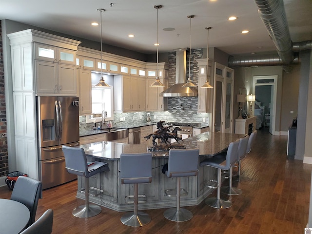 117 N 2nd, Paducah, KY 42001 - kitchen with stainless steel appliances, wall chimney exhaust hood, decorative backsplash, dark wood-type flooring, and glass insert cabinets