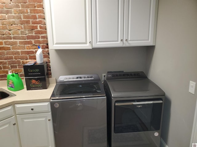 117 N 2nd, Paducah, KY 42001 - laundry area with separate washer and dryer, cabinet space, and brick wall