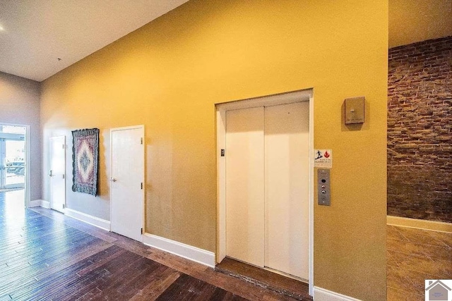 117 N 2nd, Paducah, KY 42001 - corridor featuring hardwood / wood-style floors, elevator, and a towering ceiling