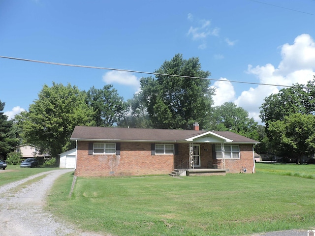 517 Milliken Rd, Paducah, KY 42003 - ranch-style house featuring brick siding, a front lawn, dirt driveway, and a detached garage