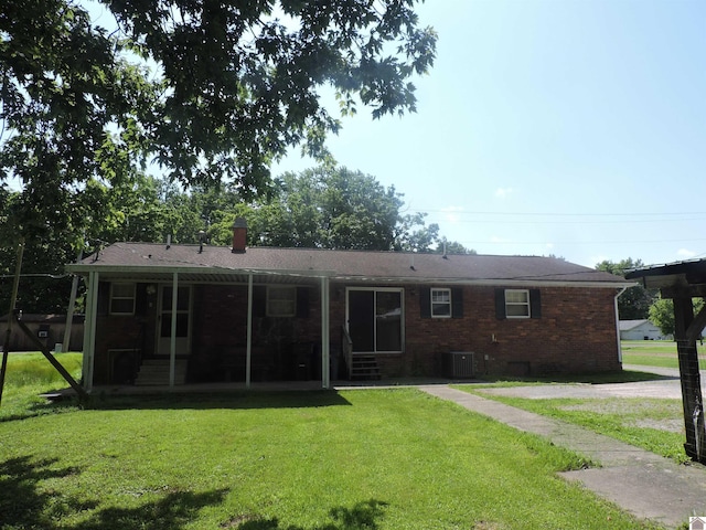 517 Milliken Rd, Paducah, KY 42003 - back of house with a yard, brick siding, a chimney, and entry steps