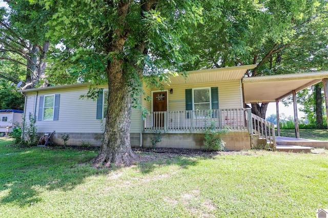 1715 State Route 80 W, Arlington, KY 42021 - view of front of home with covered porch, a front yard, and an attached carport