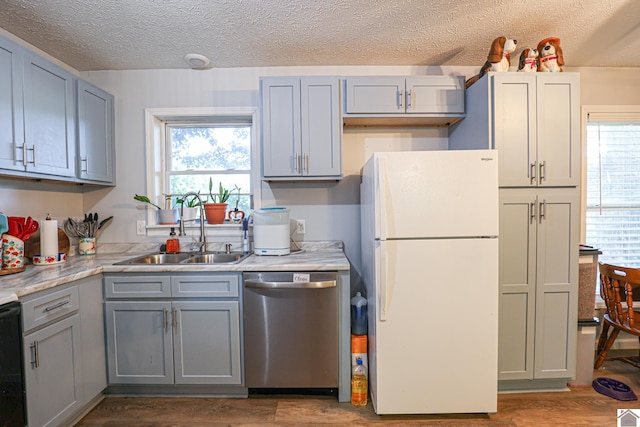 1715 State Route 80 W, Arlington, KY 42021 - kitchen featuring freestanding refrigerator, dishwasher, gray cabinets, healthy amount of natural light, and a textured ceiling