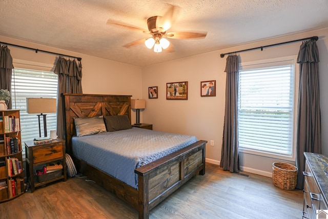 1715 State Route 80 W, Arlington, KY 42021 - bedroom with wood finished floors, a textured ceiling, and a ceiling fan