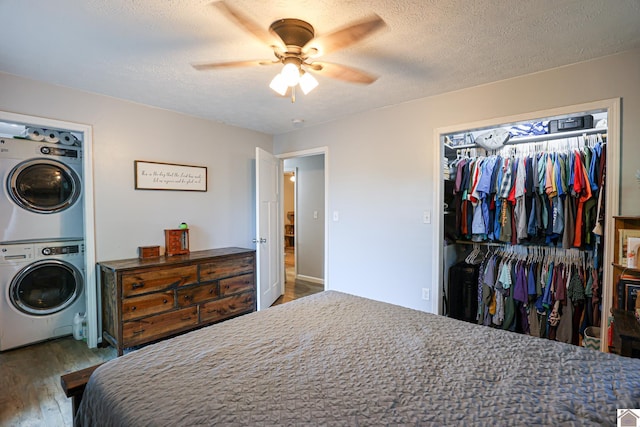 1715 State Route 80 W, Arlington, KY 42021 - bedroom with estacked washer and dryer, wood finished floors, a closet, a textured ceiling, and ceiling fan