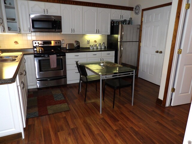 907 State Route 819 N, Kuttawa, KY 42055 - kitchen featuring appliances with stainless steel finishes, decorative backsplash, and white cabinetry