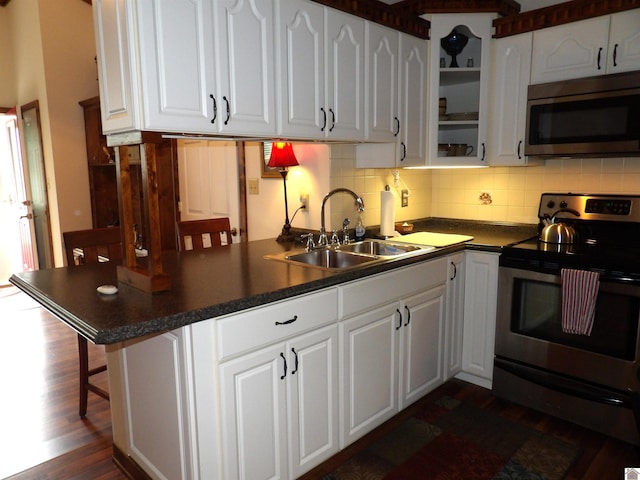 907 State Route 819 N, Kuttawa, KY 42055 - kitchen with appliances with stainless steel finishes, white cabinets, dark countertops, and dark wood-style flooring