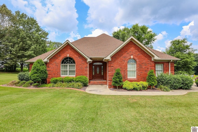 329 Royal Park Dr, Calvert City, KY 42029 - view of front of property with brick siding, a front yard, and a shingled roof