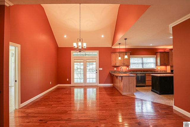 329 Royal Park Dr, Calvert City, KY 42029 - kitchen featuring dishwasher, healthy amount of natural light, light wood finished floors, a peninsula, and high vaulted ceiling