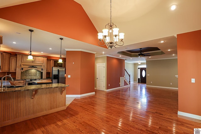329 Royal Park Dr, Calvert City, KY 42029 - kitchen featuring stainless steel appliances, a breakfast bar, ornamental molding, light wood-type flooring, and dark stone counters